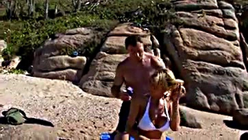 Blonde milf gets threesome on public beach